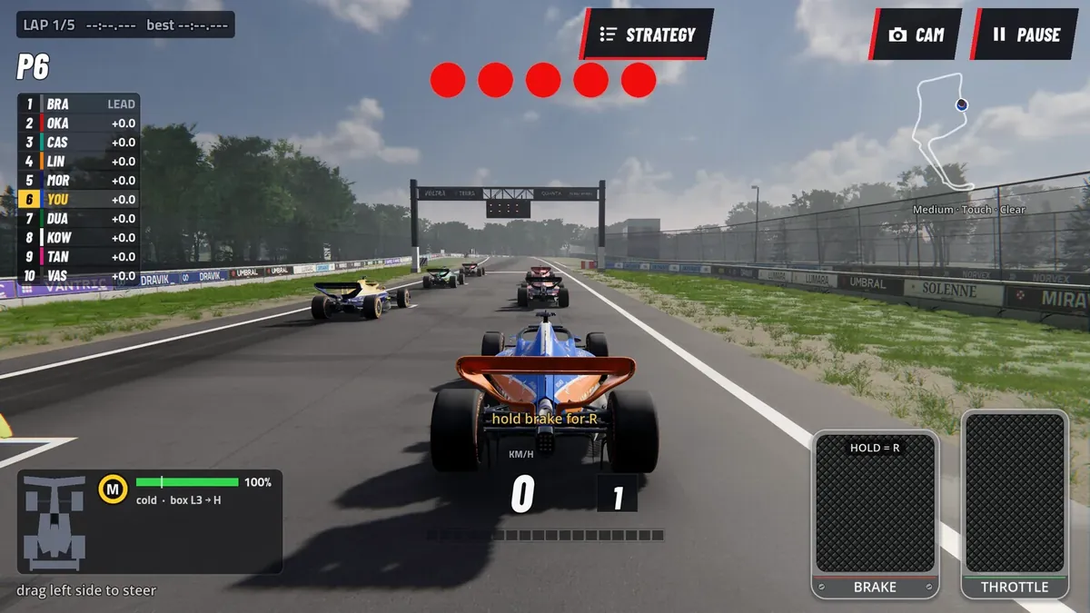 Starting grid at Apex Park: five red start lights lit above the track, the field lined up ahead